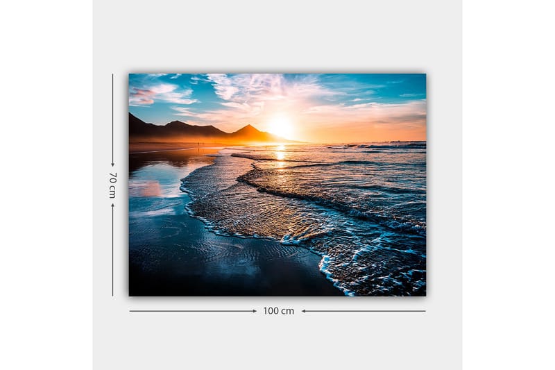 Lerretsbilde 70x100 cm - Solnedgang over en strand med milde bølger som ruller inn mot kysten - Blå / Oransje / Turkis - Innredning - Bilder & kunst - Lerretsbilder